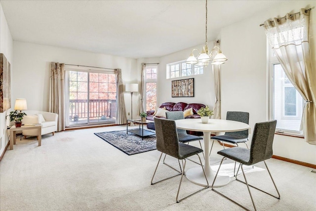 1229 Clarence St, Saint Paul, MN 55106 - dining area featuring light carpet, a chandelier, and baseboards