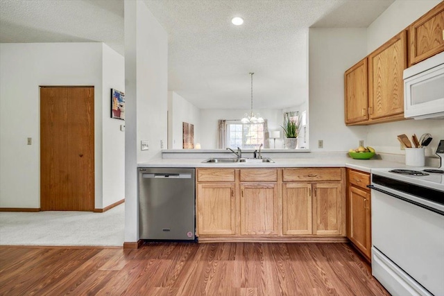 1229 Clarence St, Saint Paul, MN 55106 - kitchen featuring white appliances, a sink, dark wood-style floors, light countertops, and a chandelier
