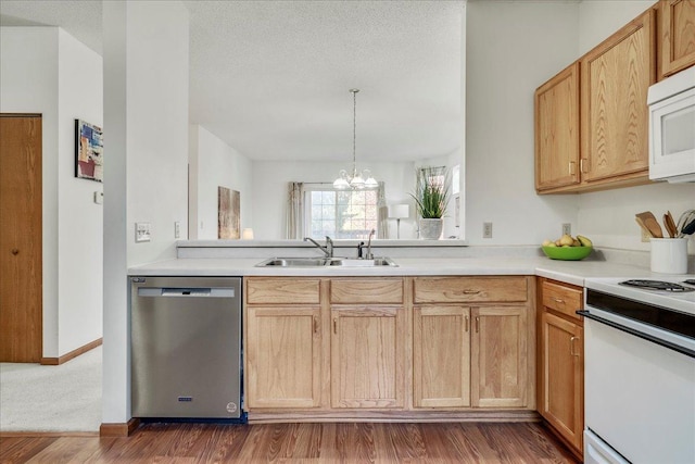 1229 Clarence St, Saint Paul, MN 55106 - kitchen featuring white appliances, a sink, a chandelier, light countertops, and wood finished floors