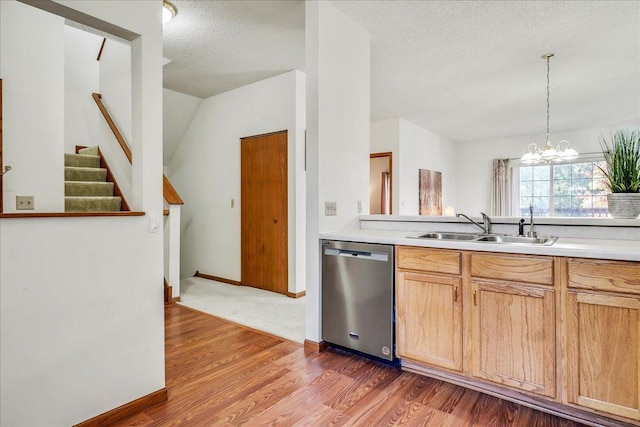 1229 Clarence St, Saint Paul, MN 55106 - kitchen with stainless steel dishwasher, a sink, a chandelier, light countertops, and wood finished floors