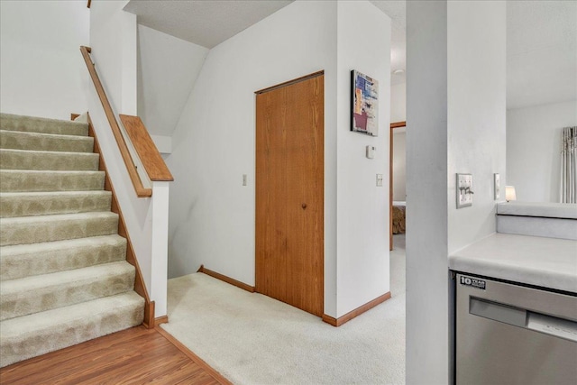 staircase featuring hardwood / wood-style flooring