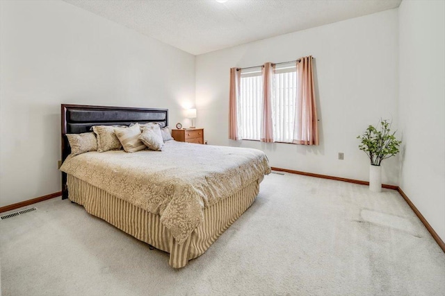 carpeted bedroom featuring a textured ceiling