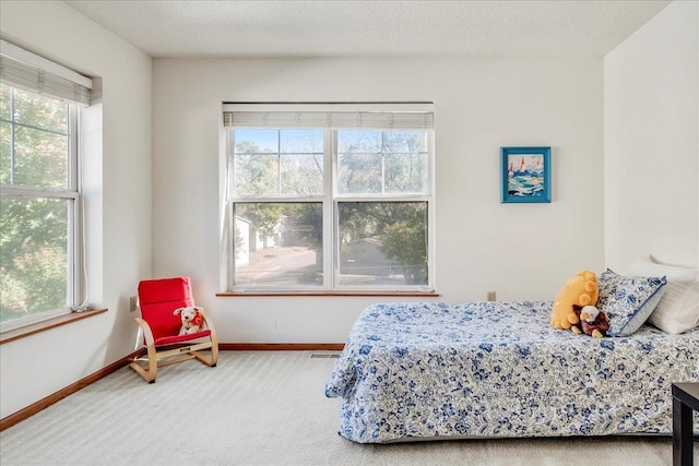 carpeted bedroom featuring a textured ceiling