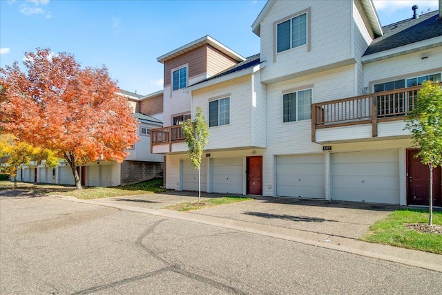 1229 Clarence St, Saint Paul, MN 55106 - view of front of house with an attached garage, driveway, and a balcony