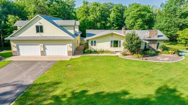 view of front of home with a garage and a front yard