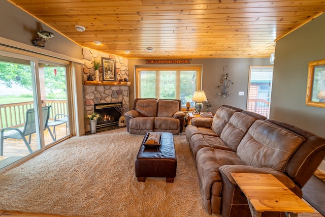 carpeted living room featuring a stone fireplace, wooden ceiling, and a healthy amount of sunlight