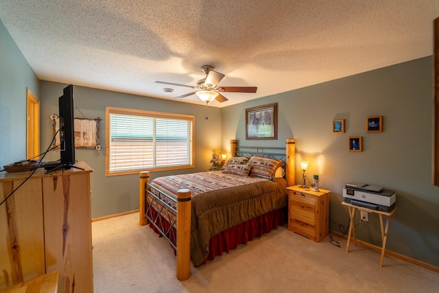 carpeted bedroom with a textured ceiling and ceiling fan