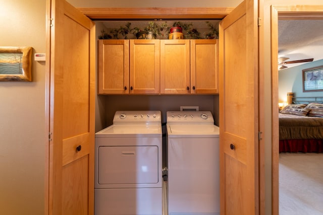 laundry room with independent washer and dryer, cabinets, and ceiling fan