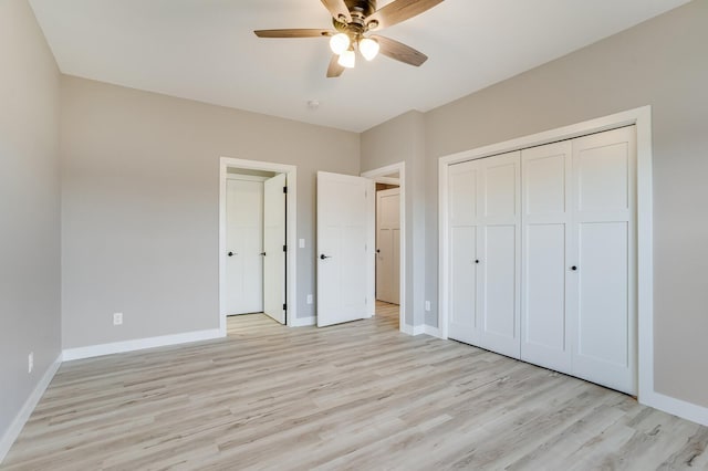 unfurnished bedroom featuring light hardwood / wood-style floors, ceiling fan, and a closet