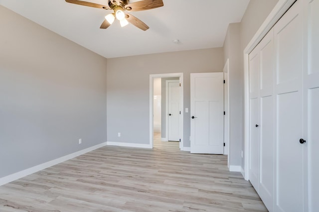 unfurnished bedroom featuring ceiling fan, light hardwood / wood-style flooring, and a closet