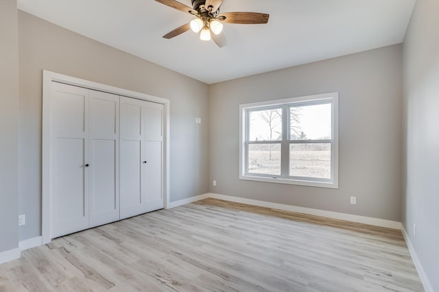 unfurnished bedroom with ceiling fan, a closet, and light hardwood / wood-style floors