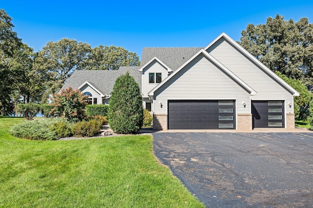 view of front of house featuring a garage and a front lawn