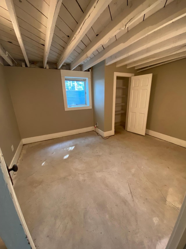 unfurnished bedroom featuring beam ceiling