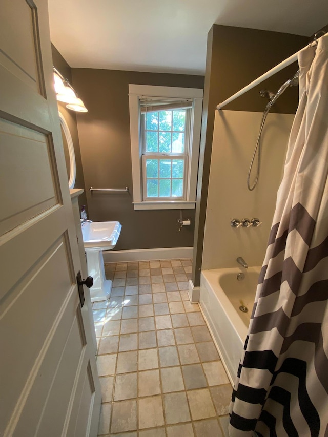 bathroom featuring shower / bath combo with shower curtain and tile patterned floors