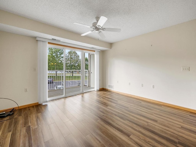 empty room with wood-type flooring, a textured ceiling, and ceiling fan