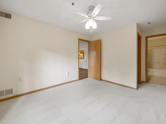 unfurnished bedroom featuring connected bathroom, ceiling fan, and carpet floors