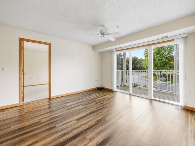 empty room with hardwood / wood-style floors, ceiling fan, and a textured ceiling