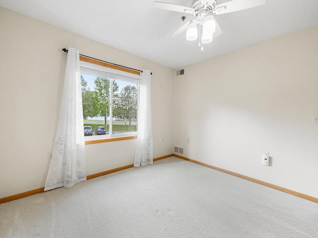 spare room with carpet and ceiling fan