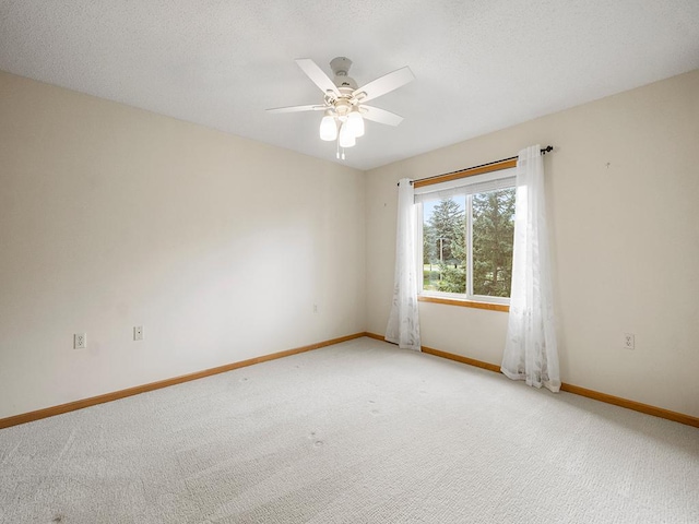 spare room with ceiling fan and light carpet