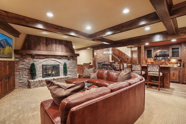 living room with light carpet, a brick fireplace, an inviting chandelier, beamed ceiling, and wood walls