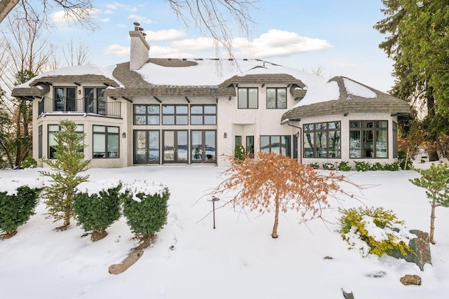 snow covered house with a balcony