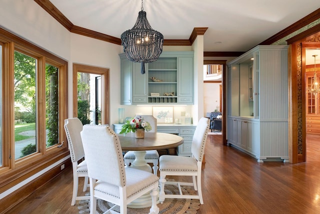 dining space featuring a notable chandelier, dark hardwood / wood-style flooring, and crown molding