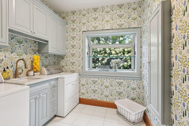 clothes washing area featuring cabinets, light tile patterned floors, and sink