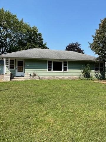 rear view of house featuring a lawn