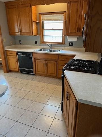 kitchen featuring light tile patterned floors, dishwasher, range with gas cooktop, and sink