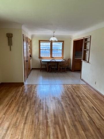 interior space with a notable chandelier and hardwood / wood-style flooring