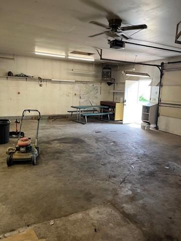 garage with ceiling fan and a garage door opener