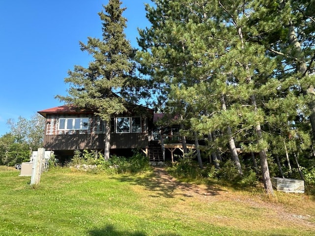 7155 Oak Narrows Rd, Greenwood Twp, MN 55723 - view of green lawn with stairway and a wooden deck