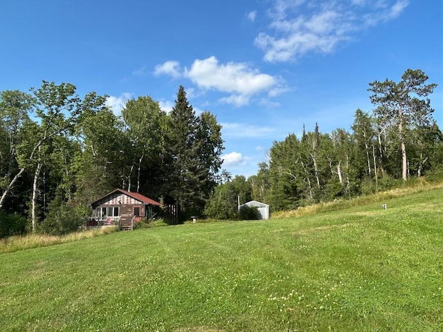 7155 Oak Narrows Rd, Greenwood Twp, MN 55723 - view of grassy yard featuring a forest view