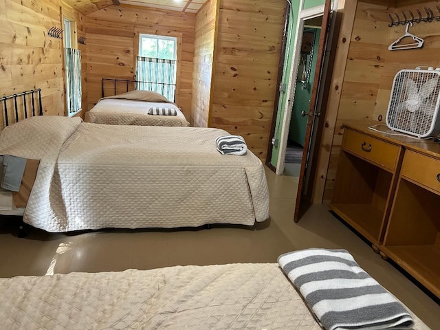 7155 Oak Narrows Rd, Greenwood Twp, MN 55723 - bedroom with wooden walls and concrete flooring