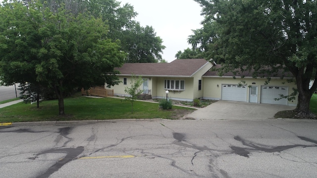 ranch-style house with a garage and a front yard