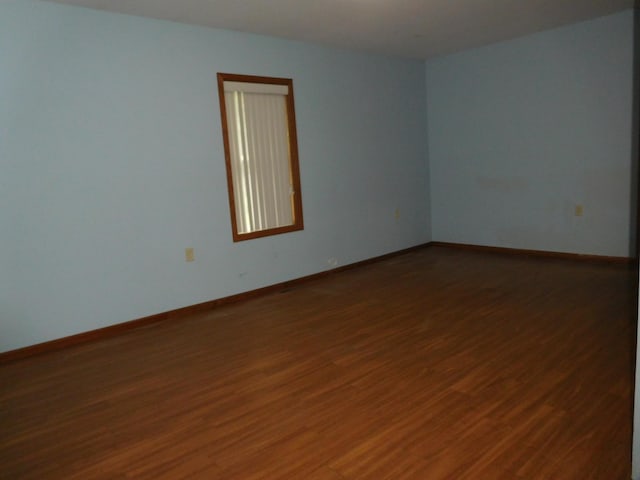 spare room with dark hardwood / wood-style floors