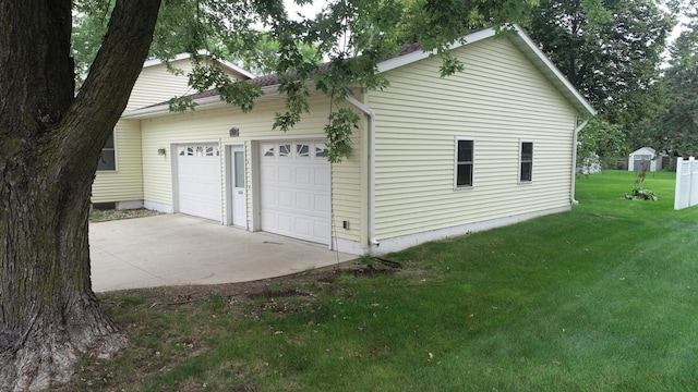 view of property exterior featuring a yard and a garage