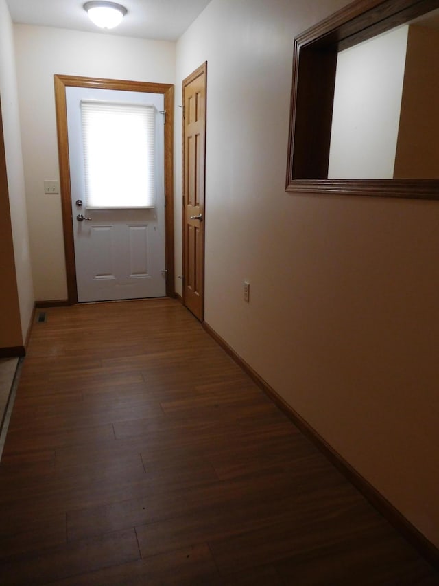 doorway to outside with dark wood-type flooring