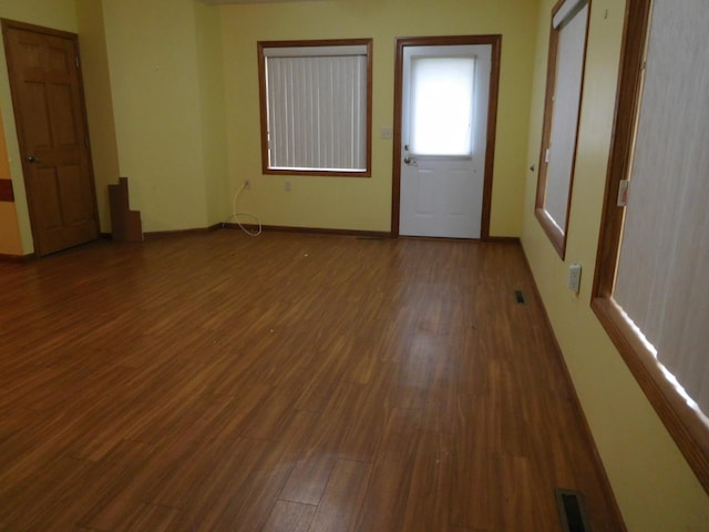 spare room with dark hardwood / wood-style floors