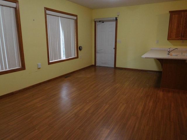 interior space with sink and dark wood-type flooring