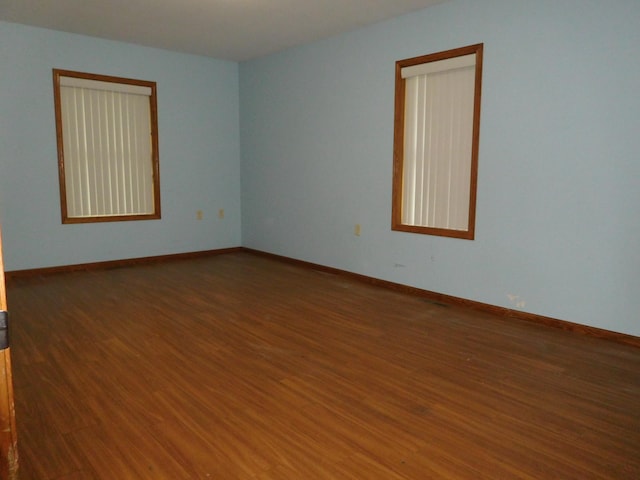 spare room featuring dark hardwood / wood-style flooring