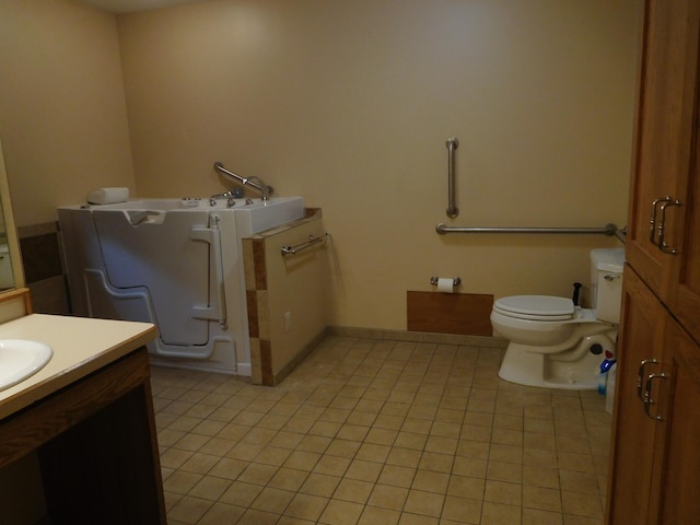 bathroom with tile patterned flooring, vanity, and toilet