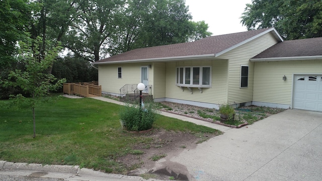 single story home featuring a garage and a front lawn