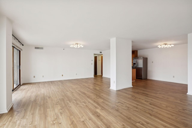 unfurnished living room with light hardwood / wood-style floors