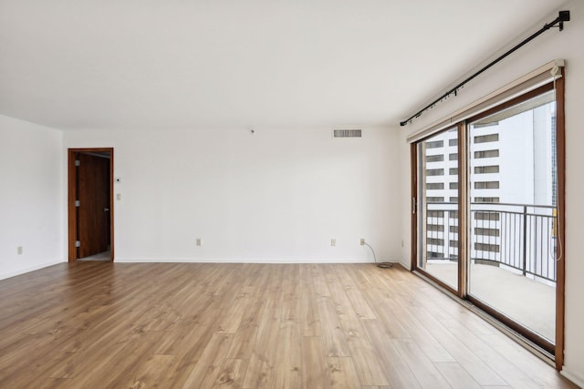 spare room with light hardwood / wood-style flooring