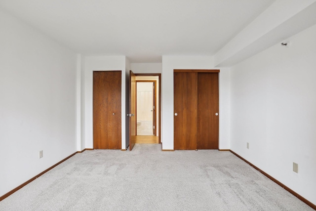 unfurnished bedroom with light carpet