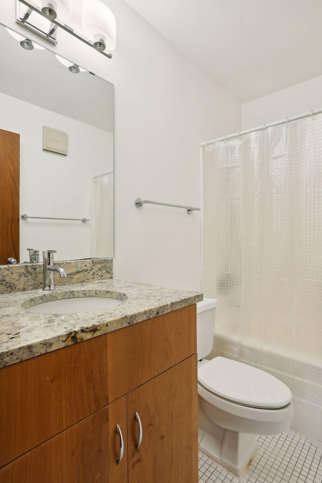 full bathroom featuring vanity, toilet, shower / bath combo with shower curtain, and tile patterned flooring