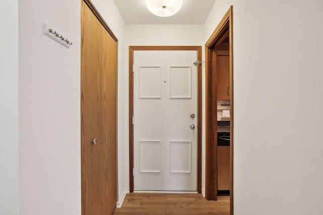 hall with light hardwood / wood-style flooring