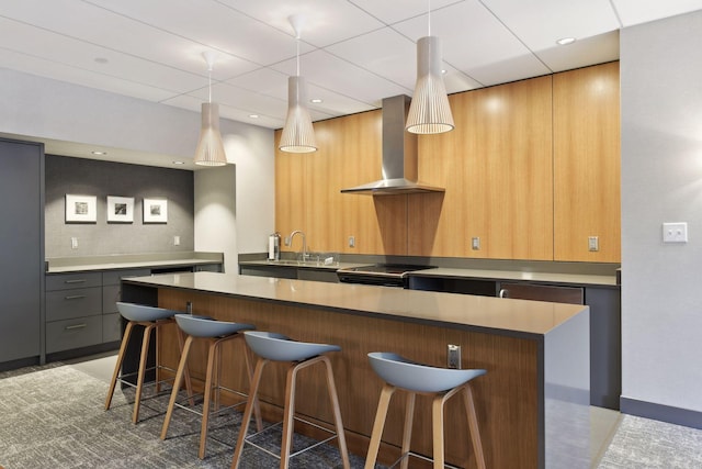 kitchen with a breakfast bar, range with electric stovetop, a center island, and wall chimney range hood