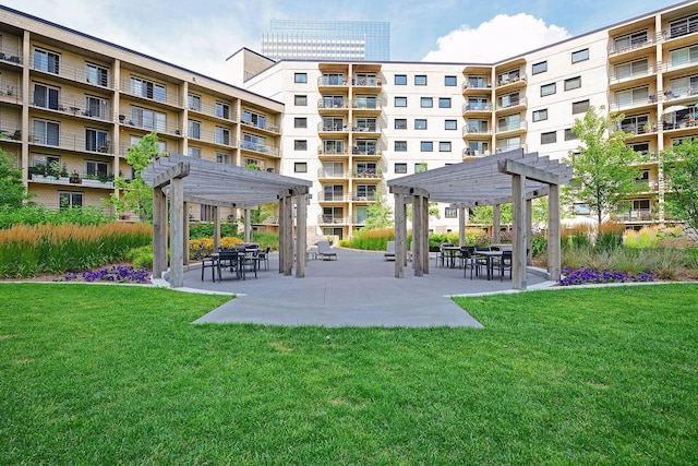 view of home's community featuring a pergola, a lawn, and a patio